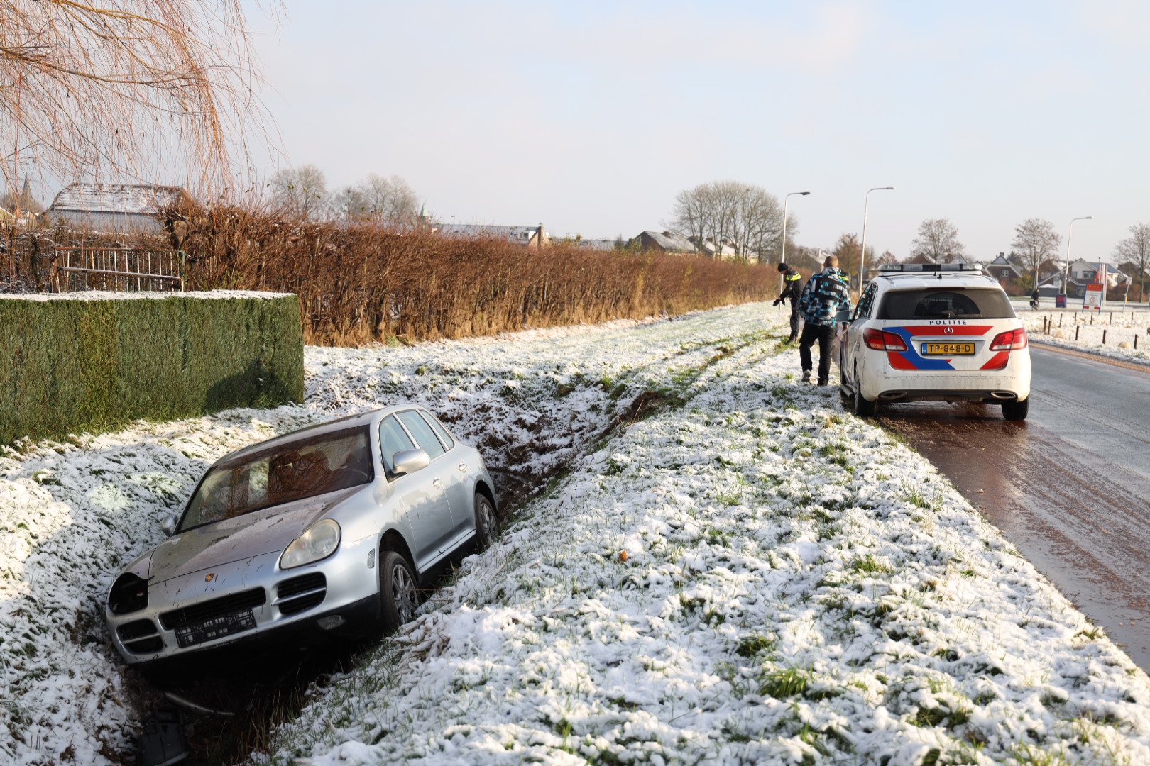 Auto vliegt uit de bocht en neemt lantaarnpaal mee de sloot in