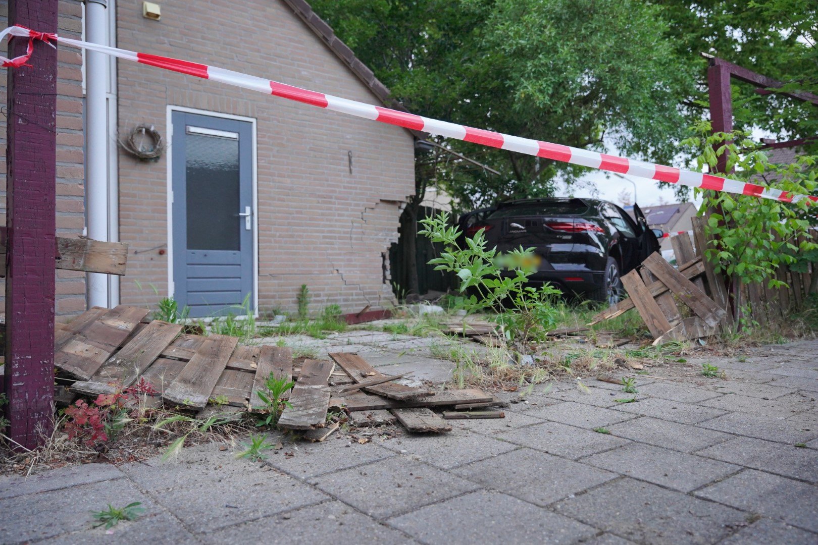 Auto rijdt door hoek van woning en komt in tuin tot stilstand